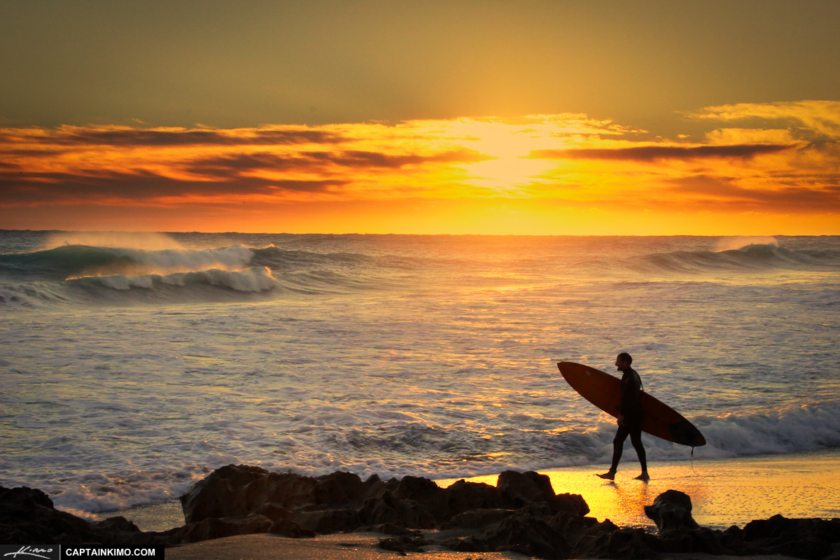 Surfer with Surfboard at Beach During Sunrise Florida